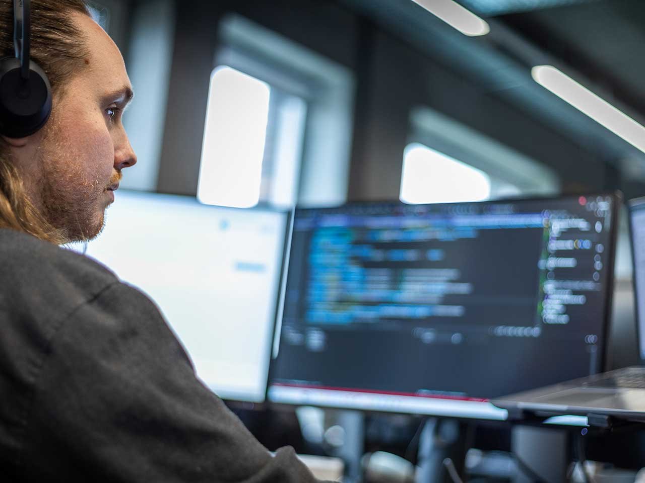 Man in the office space looking at the blurry computer screen