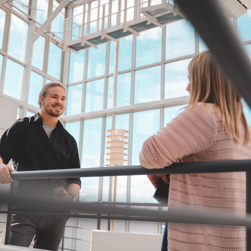  Two employees are standing on the stairs of twoday's office.